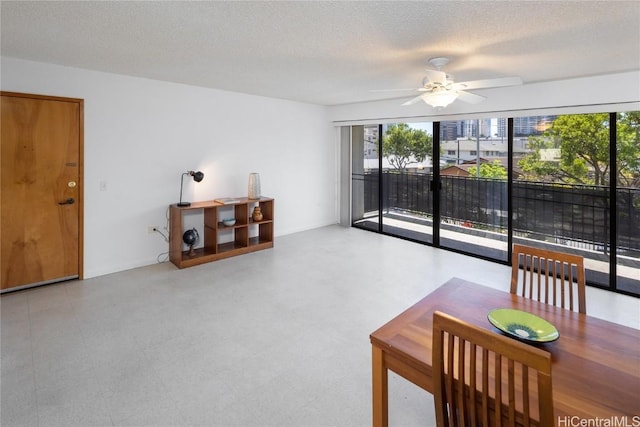 living area with a ceiling fan, a textured ceiling, and tile patterned floors