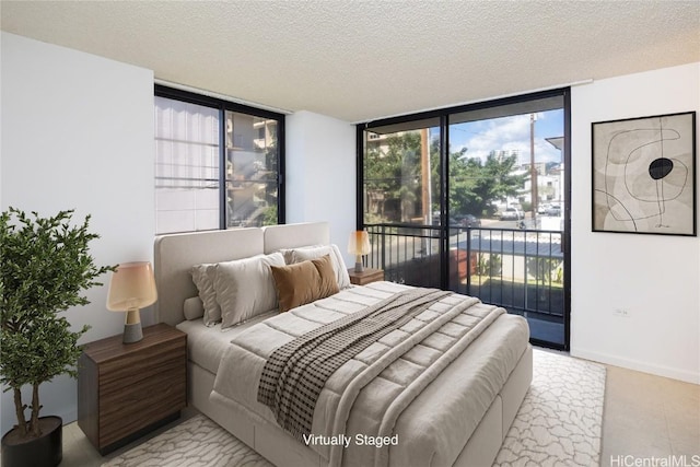 bedroom featuring a textured ceiling, access to outside, and baseboards