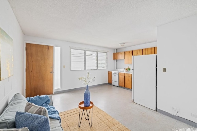 kitchen featuring white appliances and a textured ceiling