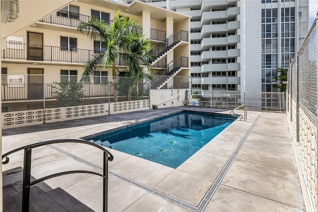 view of swimming pool featuring a patio area