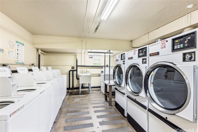 laundry area featuring sink and washer and clothes dryer