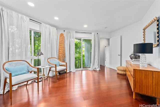 living area with plenty of natural light and hardwood / wood-style floors