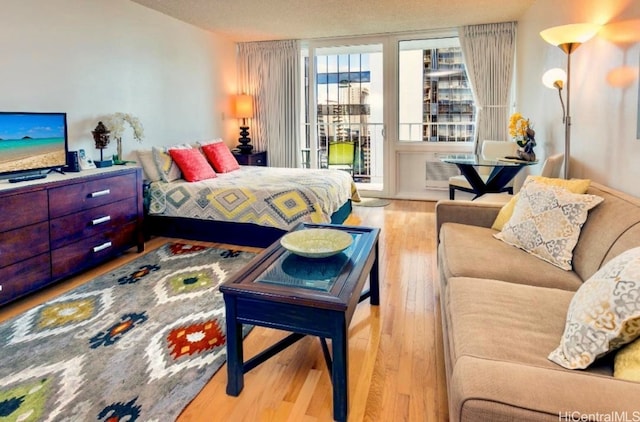 bedroom featuring access to outside and light hardwood / wood-style floors