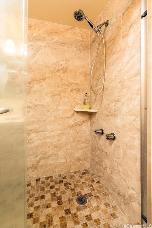 bathroom with a tile shower