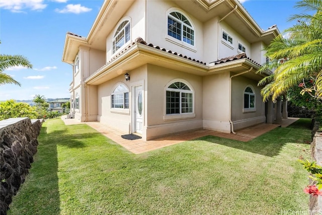 rear view of property with a yard