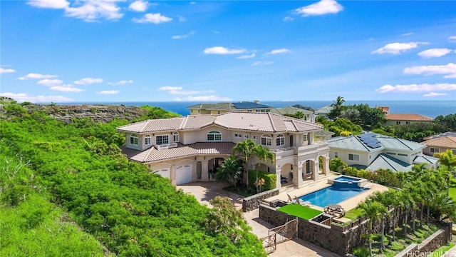 exterior space with a garage, a fenced in pool, and a patio area