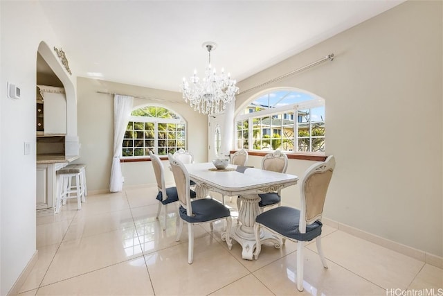 tiled dining area featuring an inviting chandelier