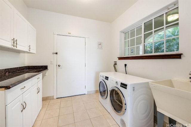 laundry room with cabinets, washer and dryer, sink, and light tile patterned floors