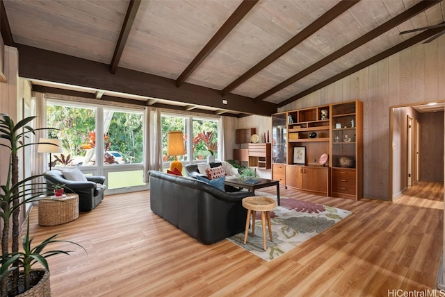 living room featuring light wood-type flooring, wood ceiling, vaulted ceiling with beams, and wood walls