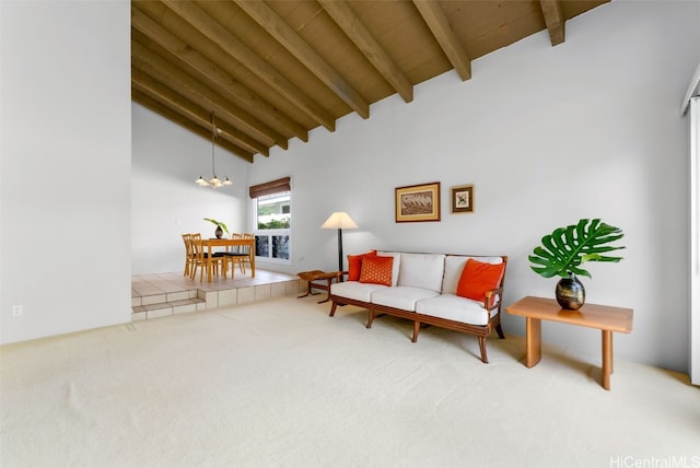 living room featuring high vaulted ceiling, beamed ceiling, carpet, a notable chandelier, and wooden ceiling