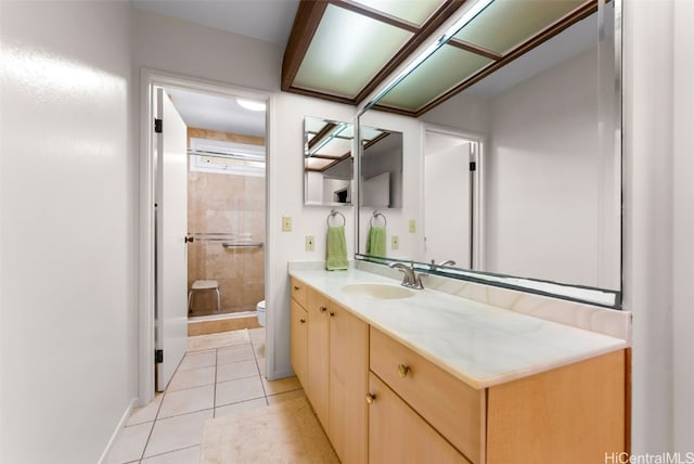 bathroom featuring vanity, tile patterned floors, and toilet