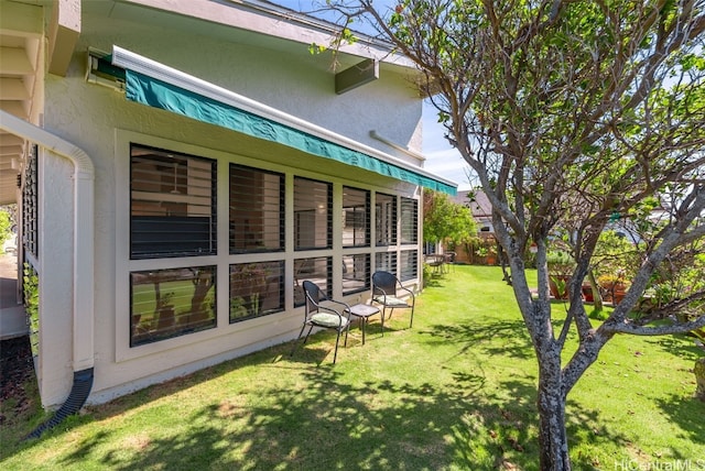 rear view of property featuring a yard