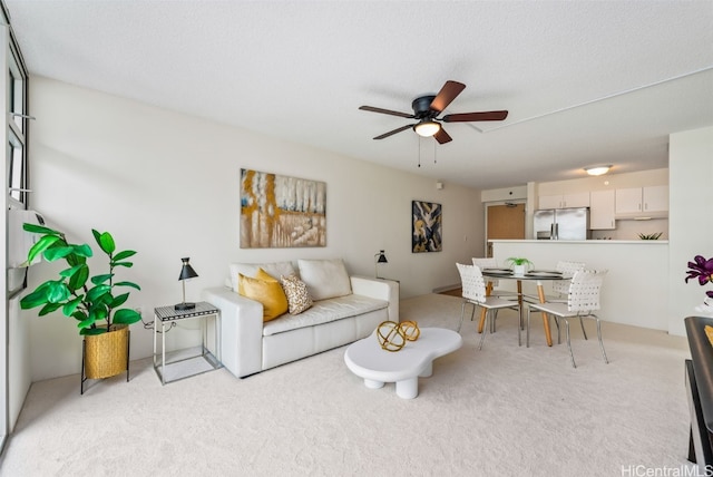 living room with light colored carpet and ceiling fan