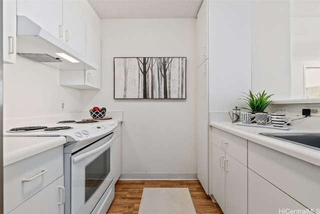 kitchen featuring white cabinetry, light hardwood / wood-style flooring, and electric stove