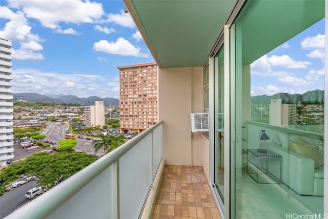 balcony featuring a mountain view and cooling unit