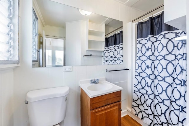 bathroom with tile walls, vanity, toilet, crown molding, and a shower with shower curtain