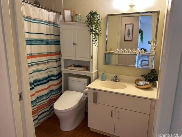 bathroom with vanity, hardwood / wood-style flooring, toilet, and walk in shower