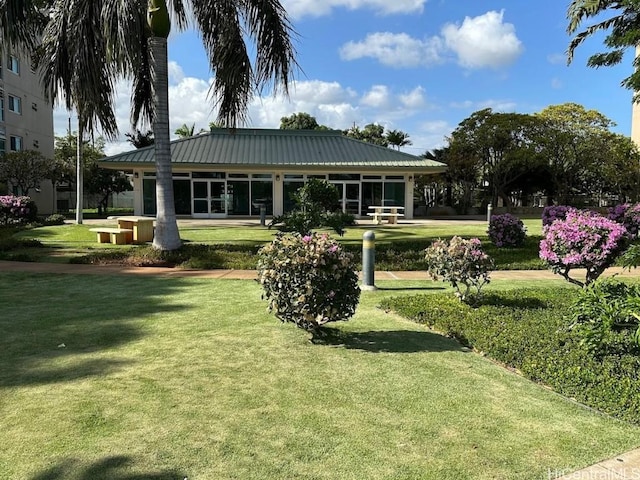 rear view of property featuring a lawn