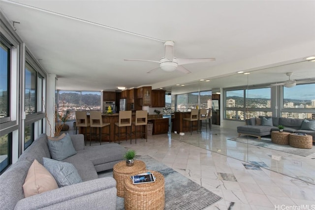 living room with a wealth of natural light and ceiling fan