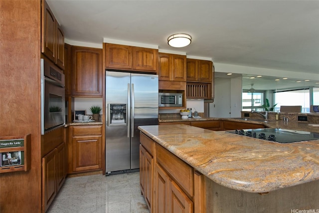 2421 Tusitala St Unit 2902/2903, Honolulu, HI 96815 - kitchen featuring light stone counters, brown cabinets, stainless steel appliances, and a sink