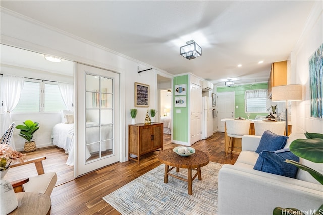 living room with ornamental molding and hardwood / wood-style floors