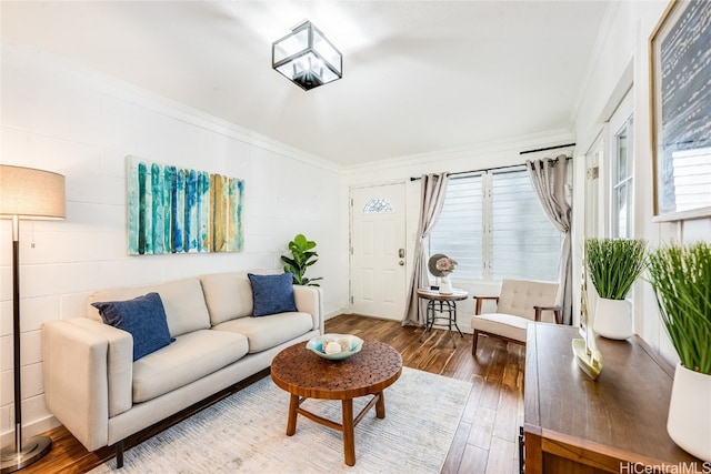 living room with wood-type flooring and ornamental molding