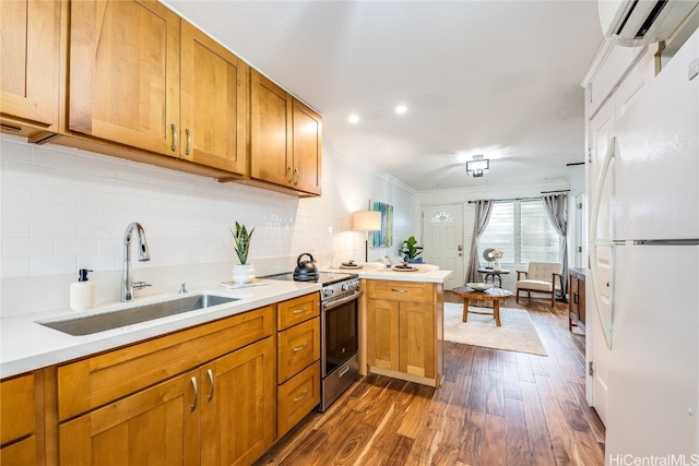 kitchen with sink, white refrigerator, dark hardwood / wood-style floors, kitchen peninsula, and electric stove