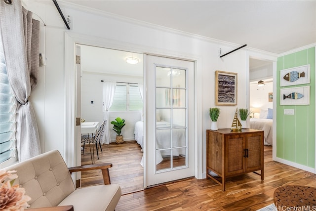 doorway featuring crown molding and wood-type flooring