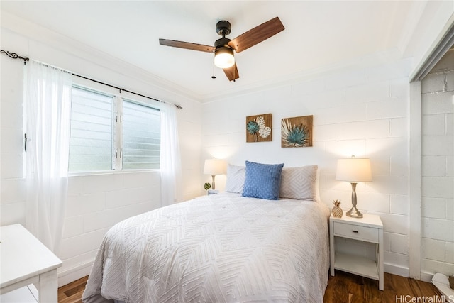 bedroom with ornamental molding, dark hardwood / wood-style floors, and ceiling fan