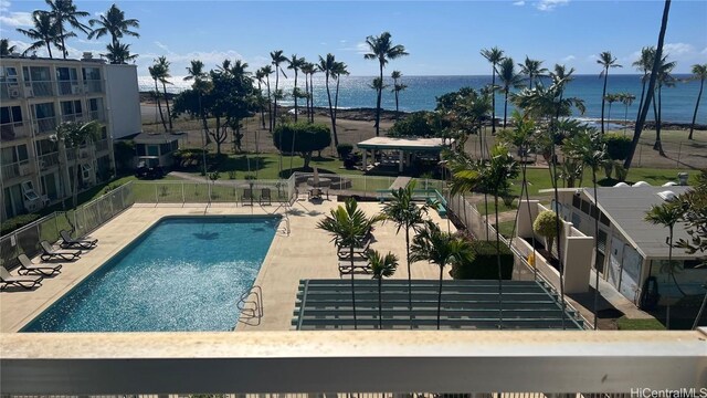 view of swimming pool with a water view and a patio area