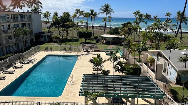 view of swimming pool with a water view and a patio