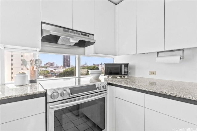 kitchen featuring white cabinetry, light stone counters, and appliances with stainless steel finishes