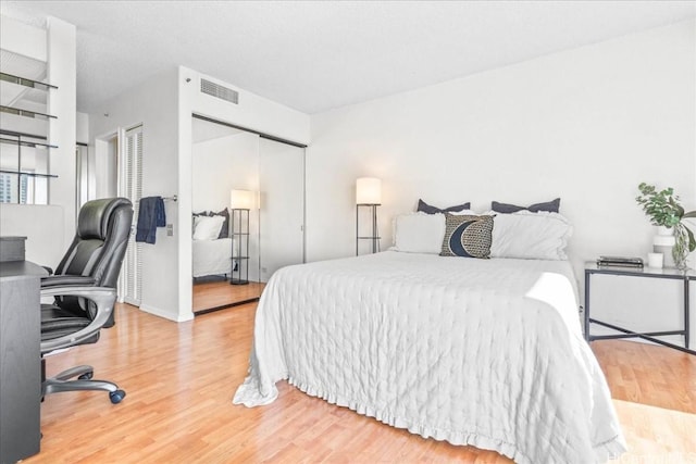 bedroom with hardwood / wood-style floors