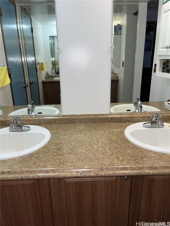 bathroom with double vanity and a sink