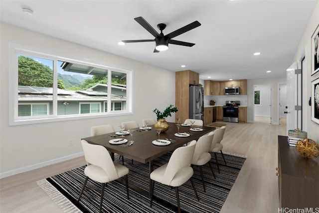 dining room with ceiling fan and light hardwood / wood-style flooring