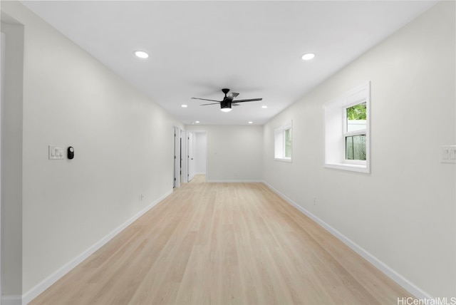 spare room featuring light hardwood / wood-style flooring and ceiling fan