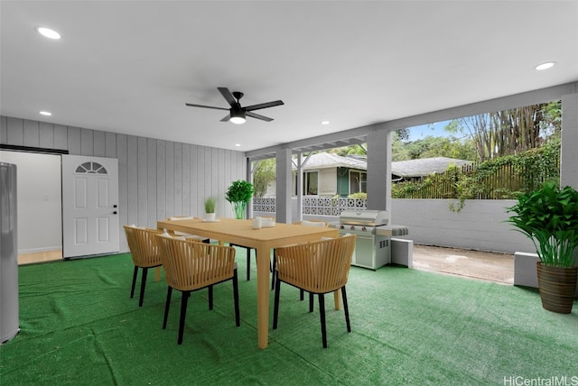 carpeted dining room featuring ceiling fan