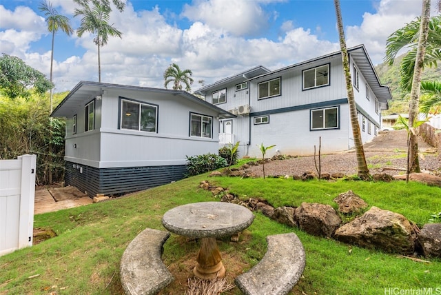 rear view of property with a lawn