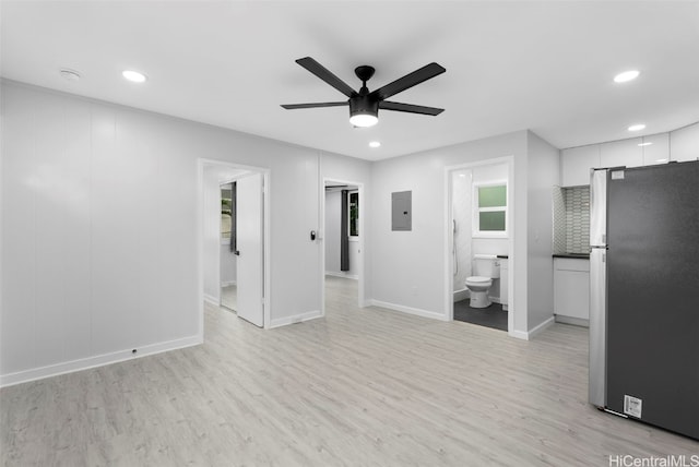 interior space featuring light hardwood / wood-style flooring, electric panel, and ceiling fan