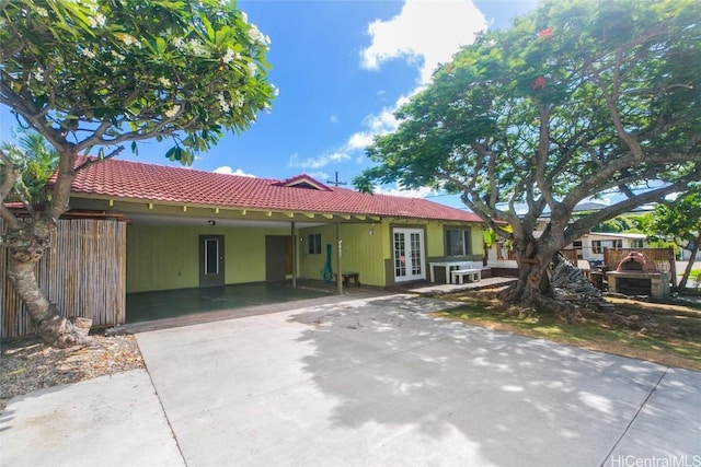 view of front of house featuring a carport and french doors