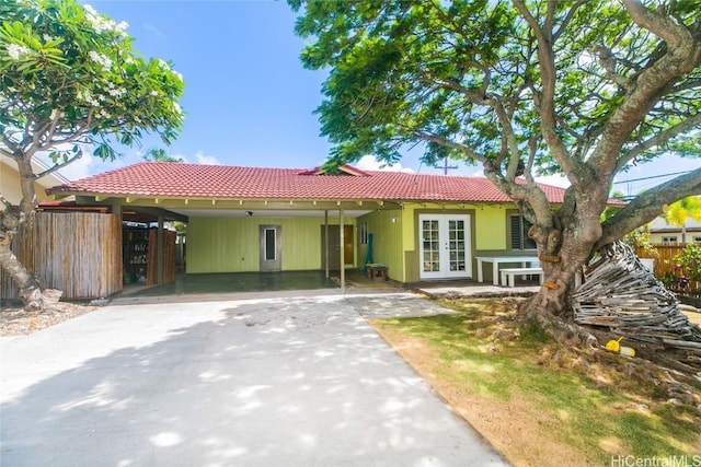 view of front of home featuring a carport and french doors