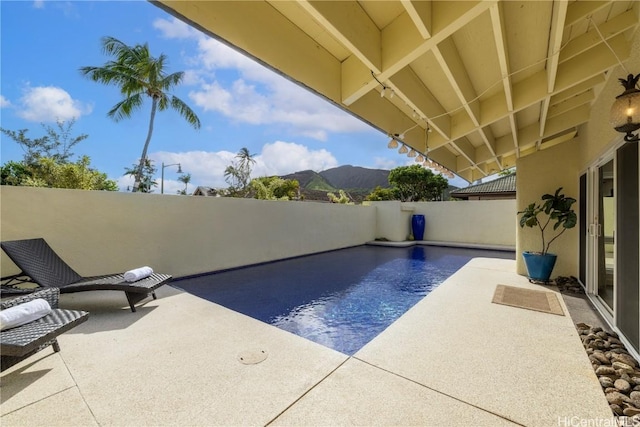 view of pool featuring a mountain view and a patio area