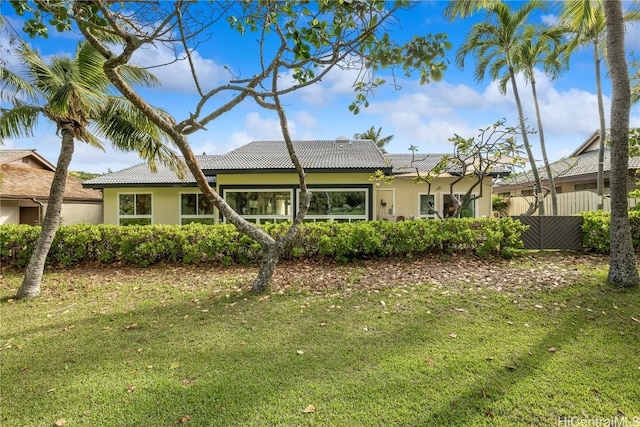 rear view of property featuring a yard