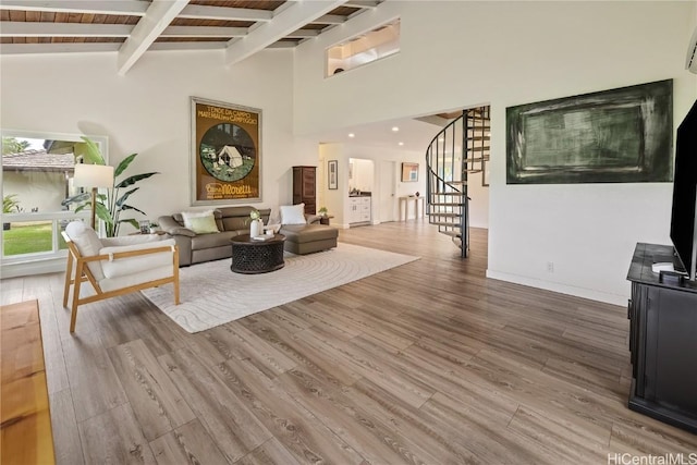 living room featuring hardwood / wood-style flooring, wood ceiling, high vaulted ceiling, and beamed ceiling