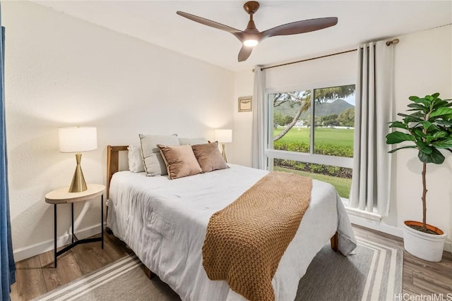 bedroom with hardwood / wood-style flooring and ceiling fan