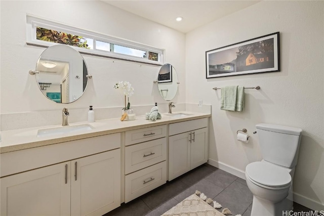 bathroom with tile patterned flooring, vanity, and toilet