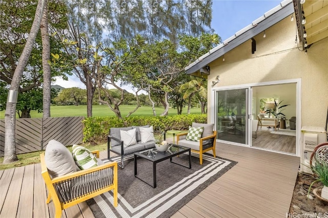 wooden terrace with an outdoor living space