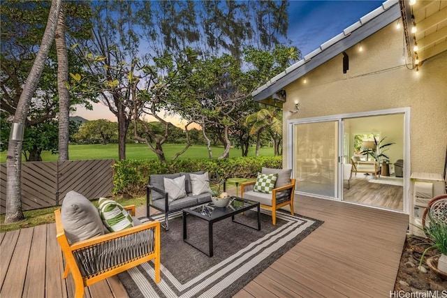 deck at dusk featuring outdoor lounge area