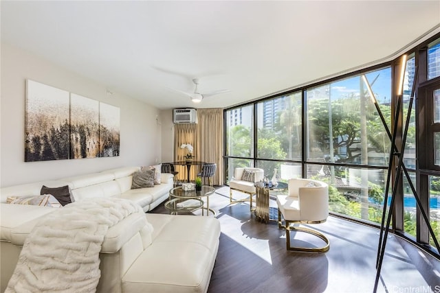 living room with hardwood / wood-style flooring, a healthy amount of sunlight, floor to ceiling windows, and an AC wall unit