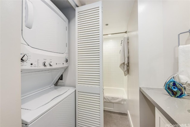 washroom featuring stacked washer and clothes dryer